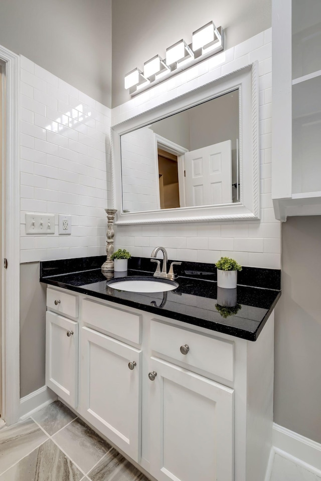 bathroom with tasteful backsplash and vanity