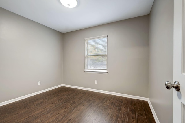 empty room with dark hardwood / wood-style floors