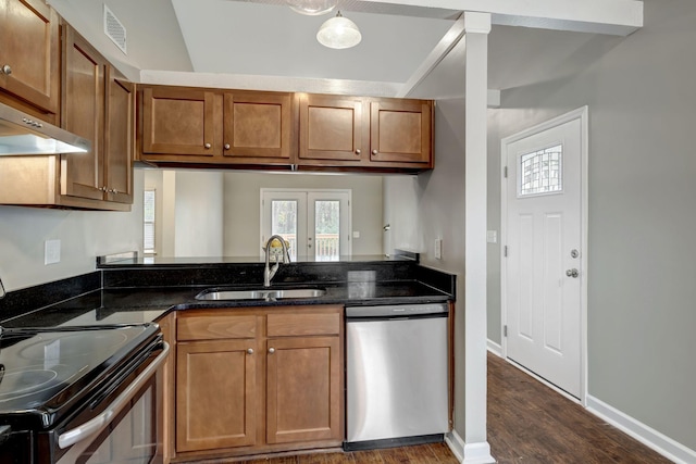 kitchen with french doors, sink, appliances with stainless steel finishes, dark hardwood / wood-style floors, and dark stone counters