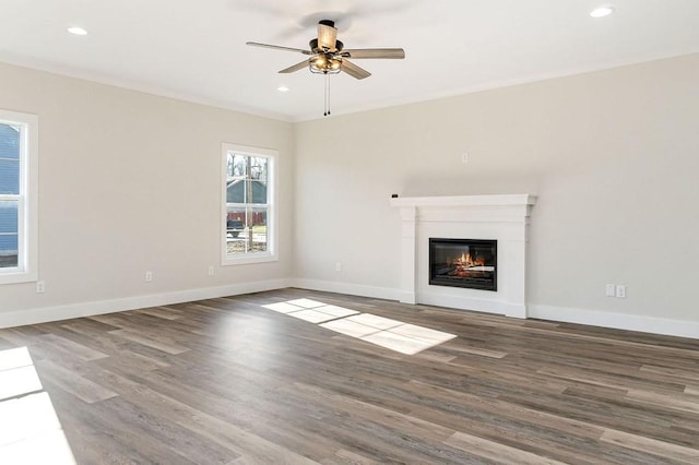 unfurnished living room with wood-type flooring and ceiling fan