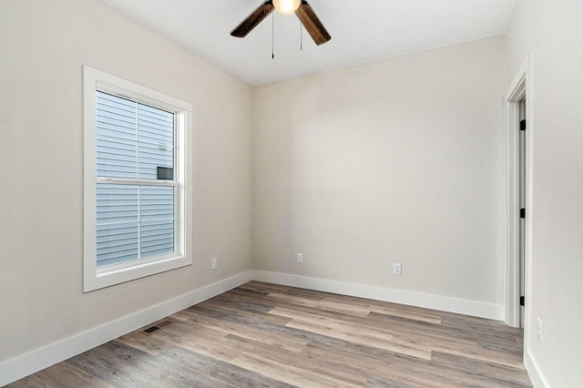 empty room featuring ceiling fan and light wood-type flooring