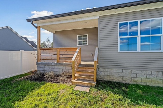 exterior space with a deck and a lawn