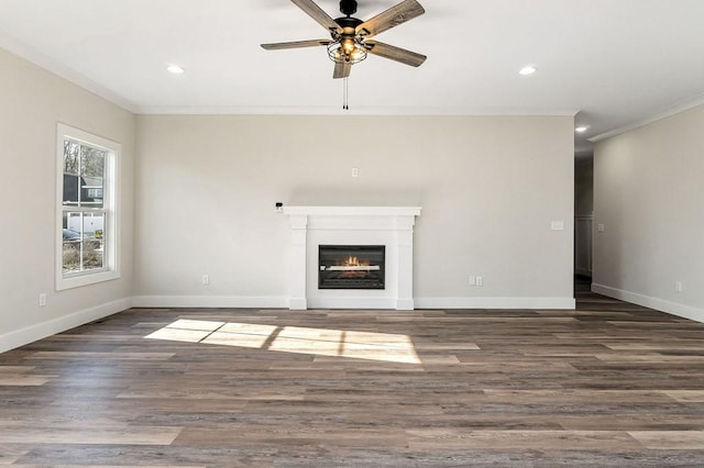 unfurnished living room with crown molding, ceiling fan, and dark hardwood / wood-style flooring