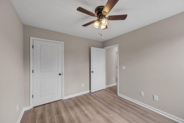 unfurnished bedroom featuring ceiling fan and light hardwood / wood-style floors