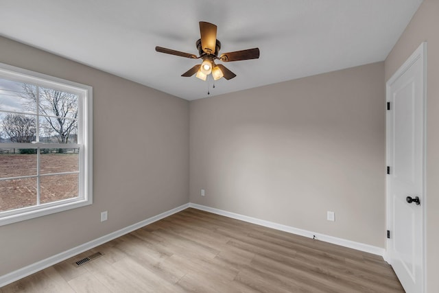 empty room with ceiling fan and light wood-type flooring