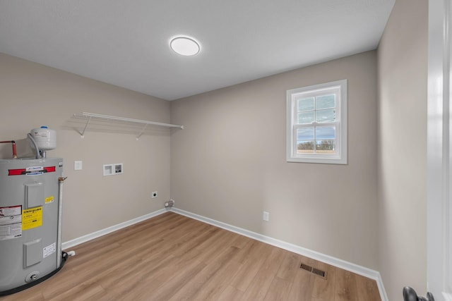 laundry room with light hardwood / wood-style floors, hookup for a washing machine, electric water heater, and electric dryer hookup