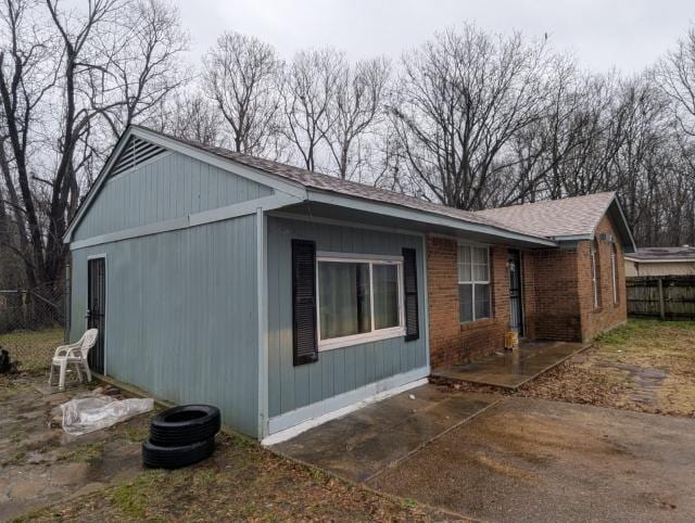 view of side of property with a patio area