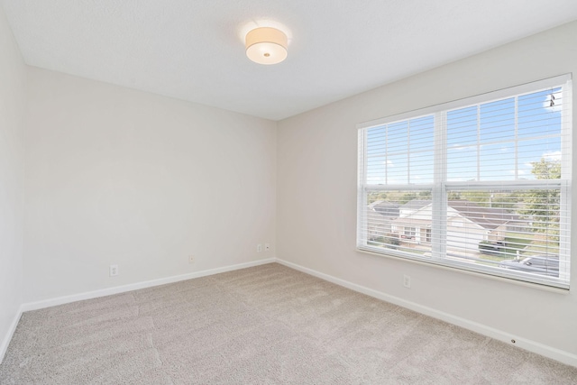 empty room featuring light carpet