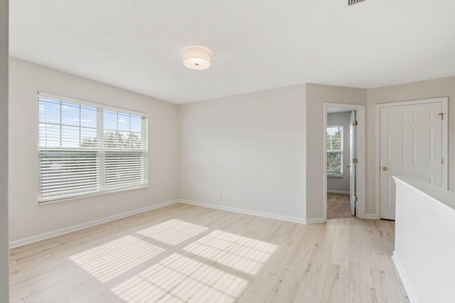 spare room with light wood-type flooring