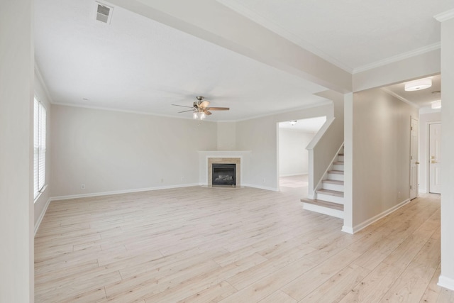 unfurnished living room featuring light hardwood / wood-style flooring, ornamental molding, and ceiling fan