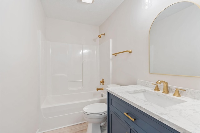 full bathroom featuring vanity, wood-type flooring, shower / washtub combination, and toilet