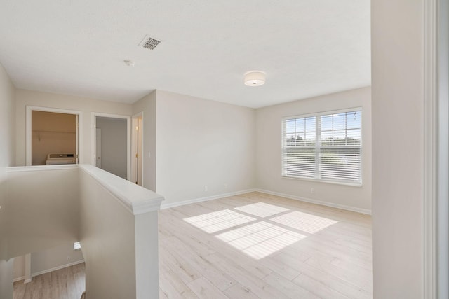 spare room featuring light hardwood / wood-style floors