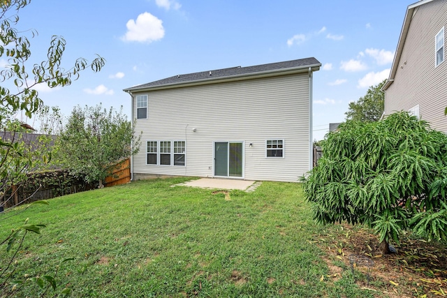 back of property featuring a lawn and a patio area