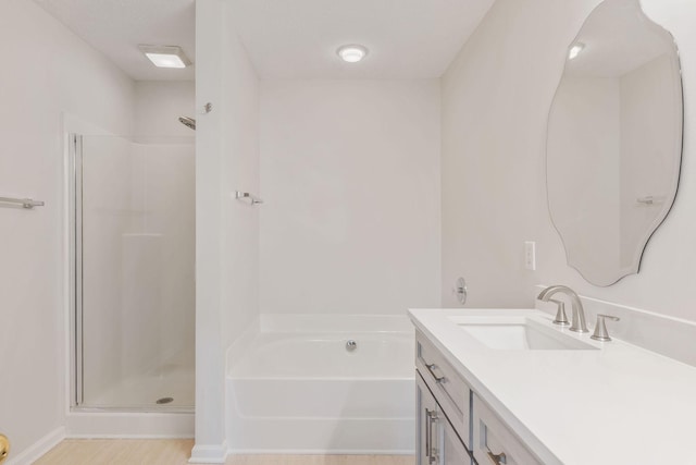 bathroom featuring vanity and independent shower and bath