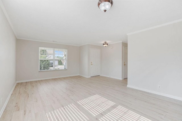 unfurnished room featuring ornamental molding and light wood-type flooring