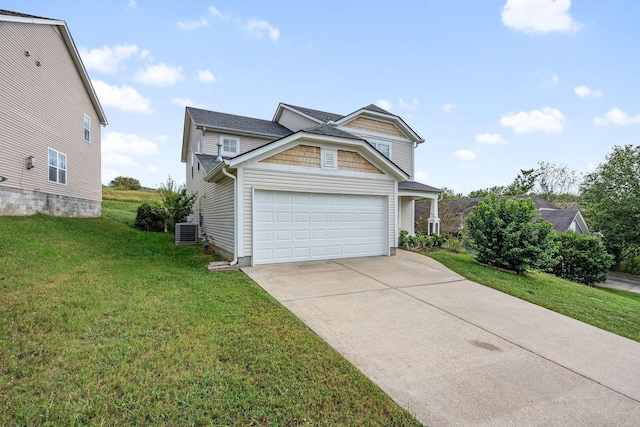 view of front of house with a garage, a front lawn, and central air condition unit