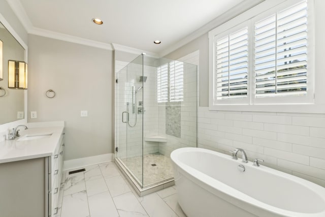 bathroom featuring ornamental molding, independent shower and bath, and vanity