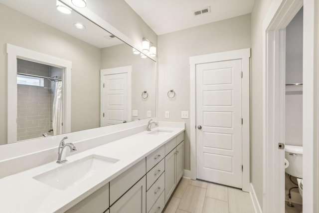 bathroom featuring vanity, a shower with shower curtain, and toilet