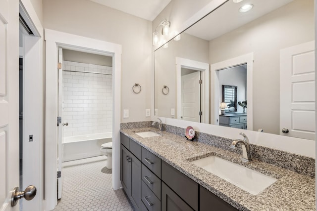 full bathroom featuring vanity, tile patterned flooring, tiled shower / bath combo, and toilet