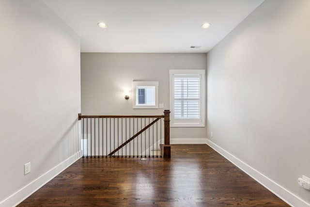 unfurnished room featuring dark hardwood / wood-style flooring