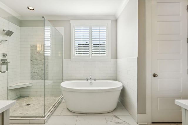 bathroom featuring ornamental molding, vanity, separate shower and tub, and tile walls