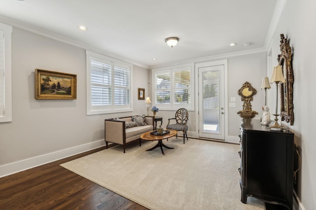 sitting room featuring hardwood / wood-style flooring and ornamental molding