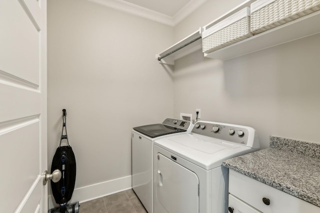 clothes washing area featuring tile patterned flooring, ornamental molding, and separate washer and dryer