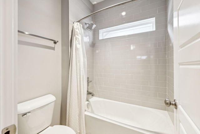 bathroom with toilet and shower / bath combo with shower curtain