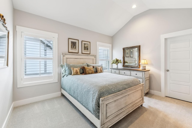 bedroom featuring vaulted ceiling and light carpet