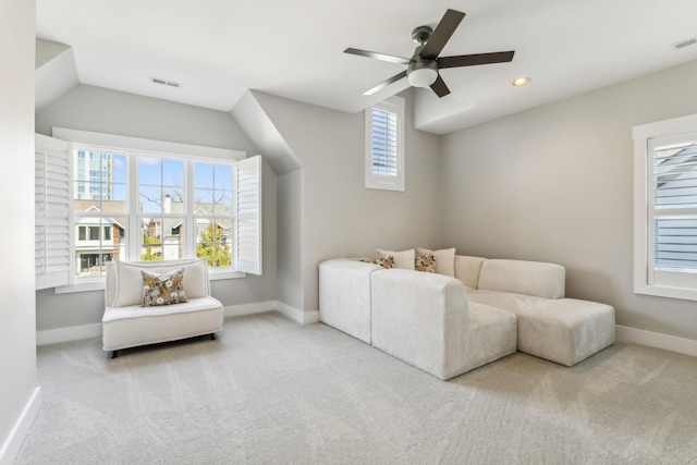 living area featuring carpet flooring and ceiling fan