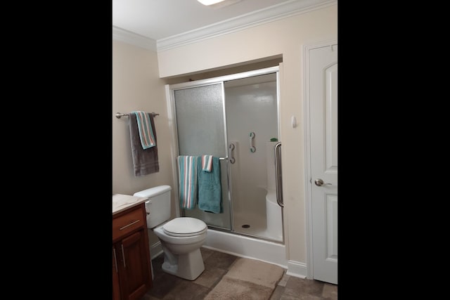 bathroom featuring crown molding, vanity, tile patterned floors, toilet, and walk in shower