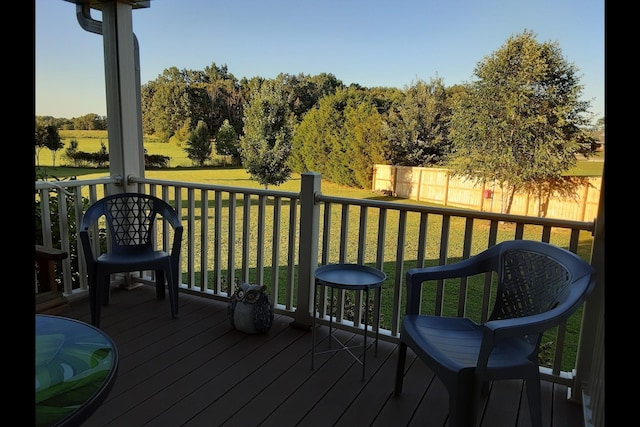 wooden terrace with a lawn