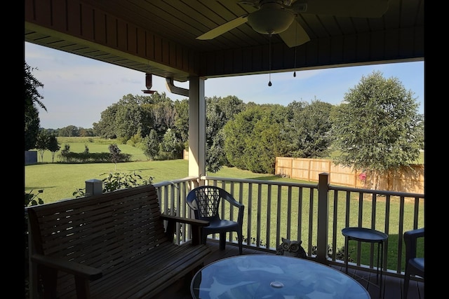 wooden terrace featuring a yard and ceiling fan