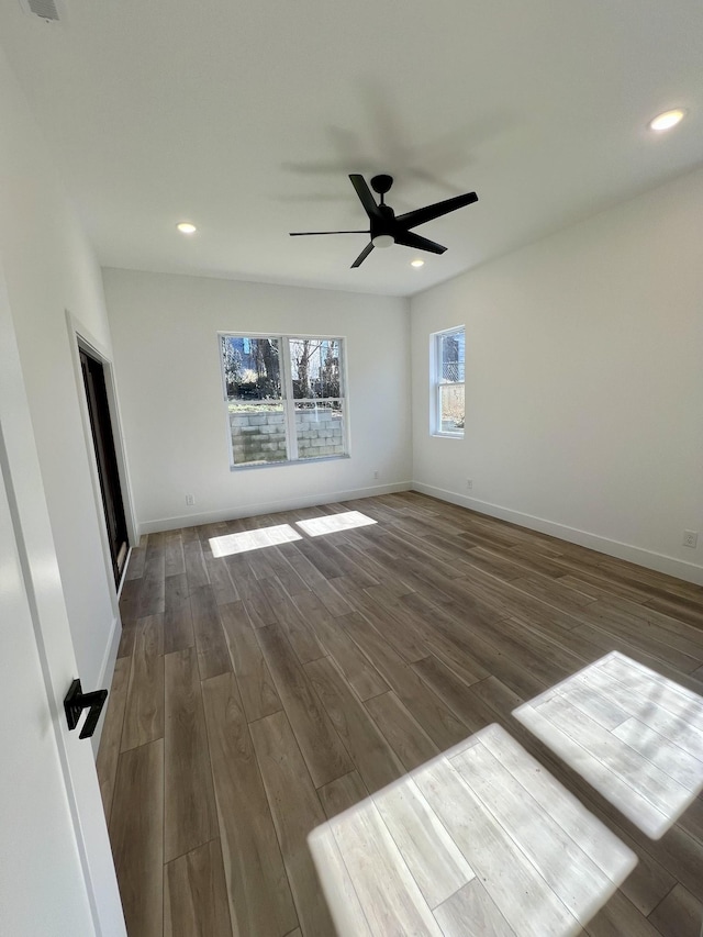 unfurnished room featuring dark wood-type flooring and ceiling fan