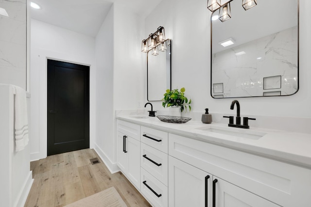 bathroom featuring vanity and hardwood / wood-style floors