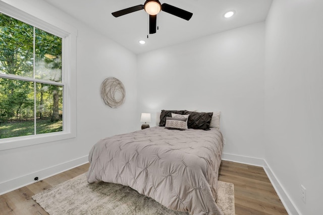 bedroom with hardwood / wood-style flooring and ceiling fan