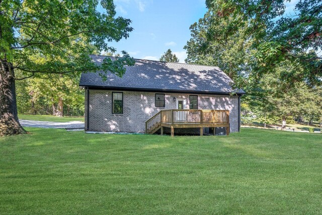 rear view of house with a yard and a deck