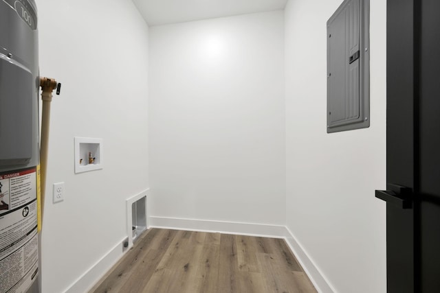 laundry room with electric panel, hookup for a washing machine, water heater, and light hardwood / wood-style flooring