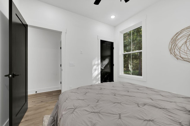 bedroom with ceiling fan and light hardwood / wood-style floors