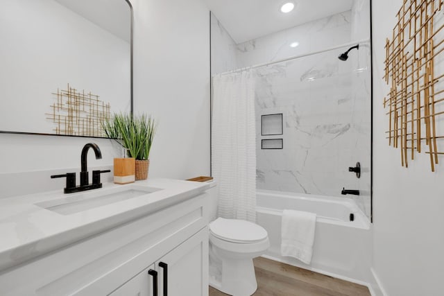 full bathroom with wood-type flooring, toilet, shower / tub combo, and vanity