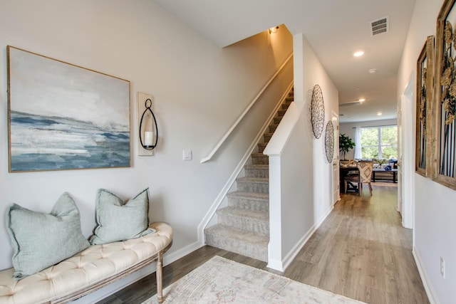 stairs with hardwood / wood-style floors