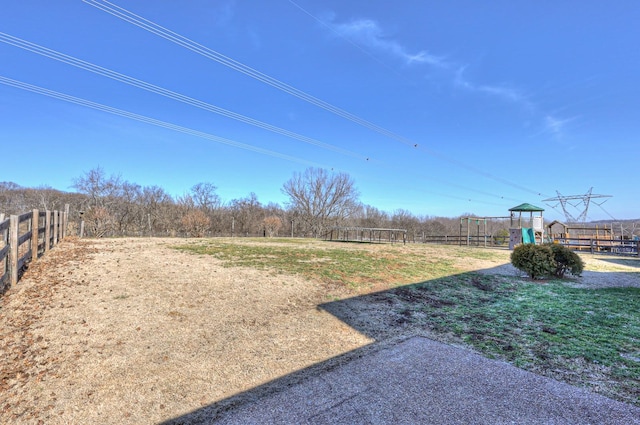 view of yard with a playground and a rural view