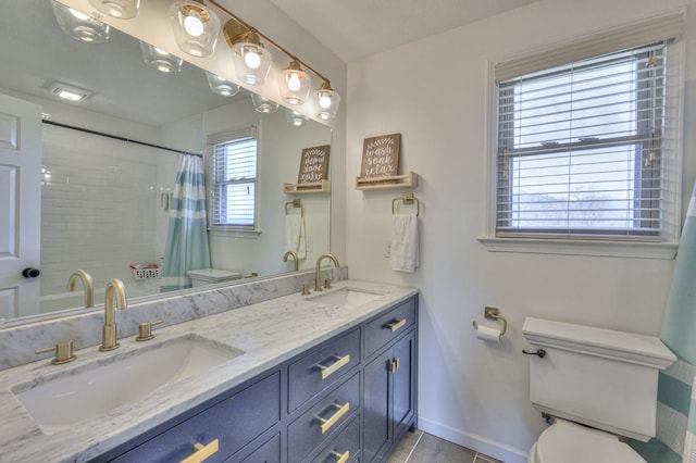 bathroom featuring a shower with curtain, vanity, and toilet