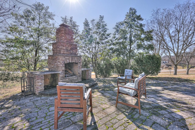 view of patio featuring an outdoor stone fireplace