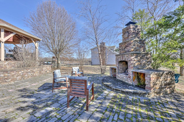 view of patio / terrace featuring an outdoor stone fireplace