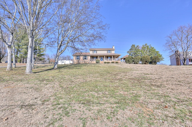 exterior space with covered porch and a front lawn