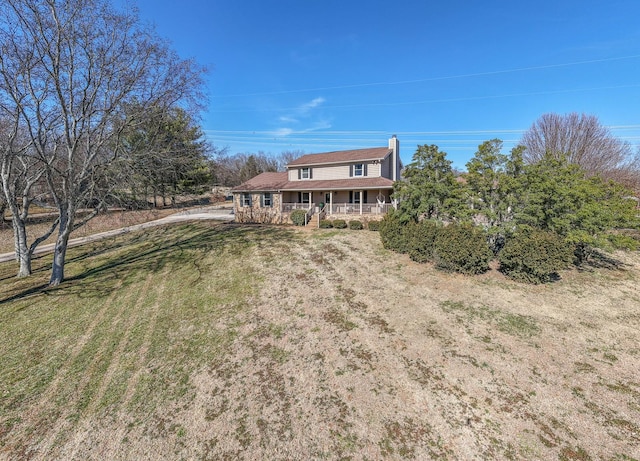 view of front of home with a front yard and a porch