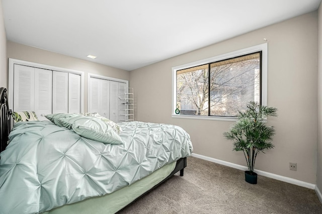 carpeted bedroom with multiple closets