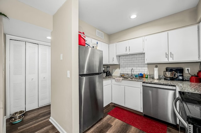 kitchen with white cabinetry, appliances with stainless steel finishes, dark hardwood / wood-style flooring, and sink