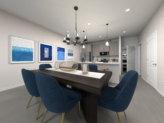 dining space with hardwood / wood-style floors and a notable chandelier